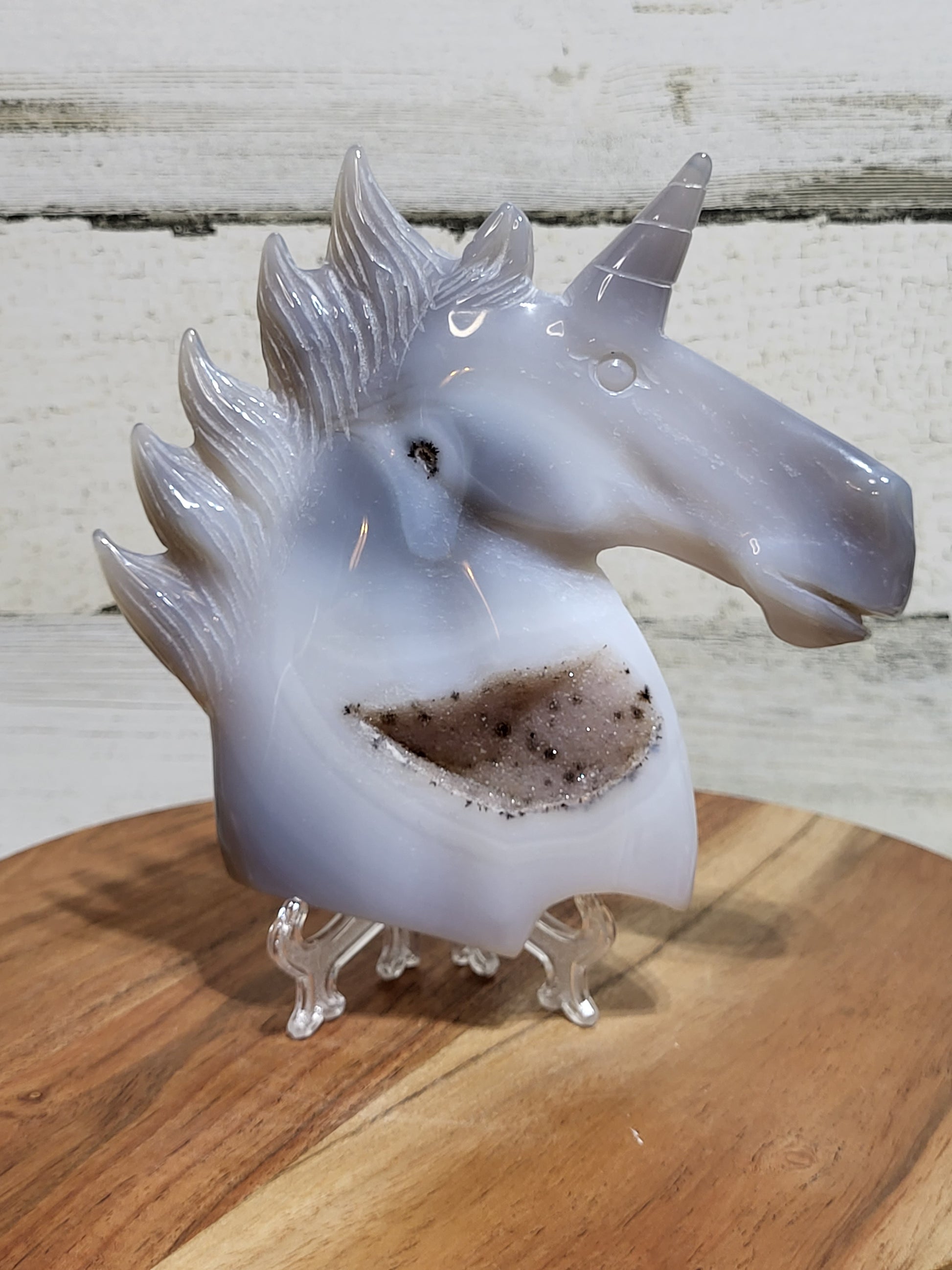 Unicorn carving in gray-toned agate with large druzy
