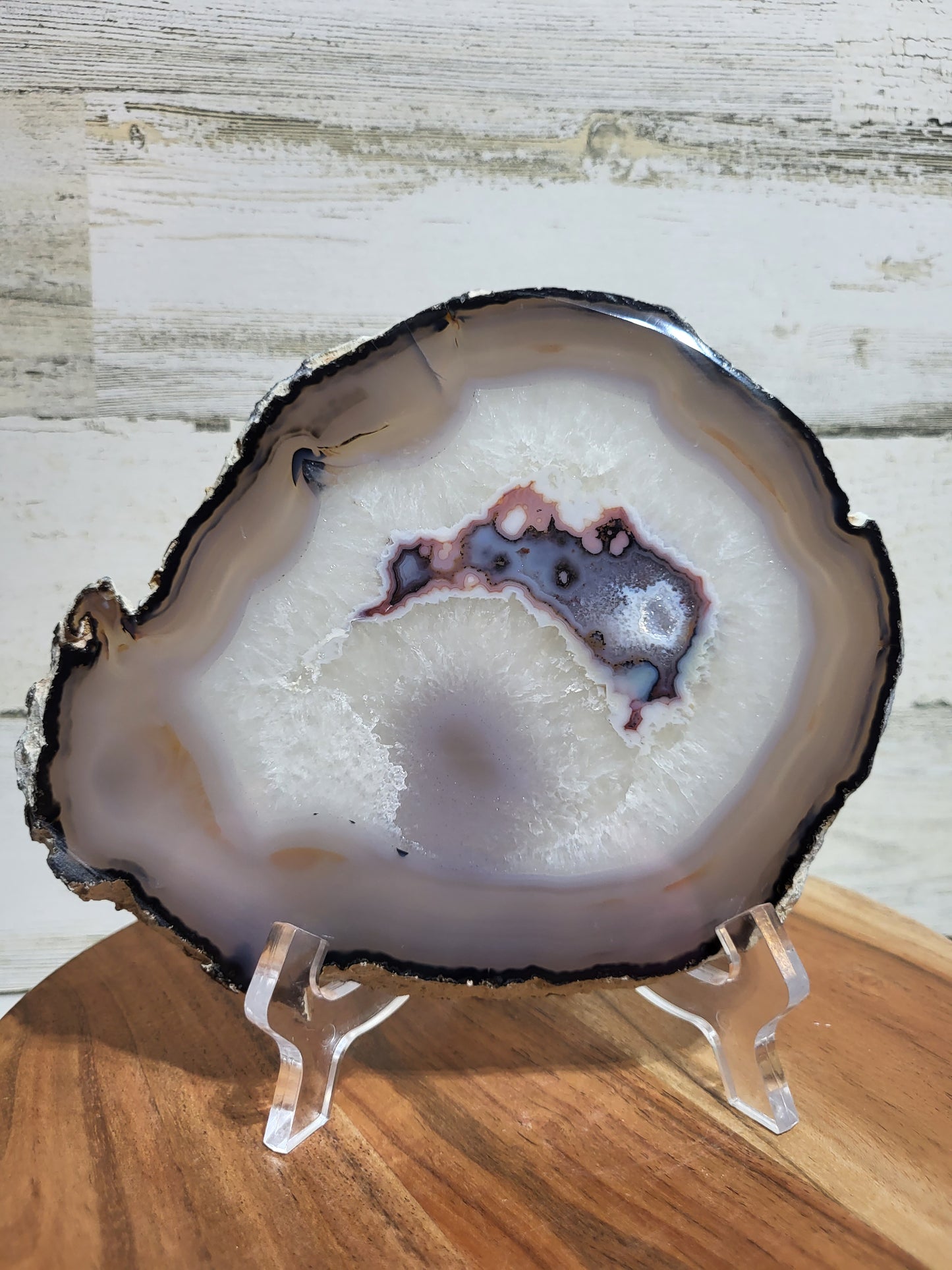 Gray chalcedony, outlined with a black band surrounding a beautiful Quartz center with pink, blue and purple inclusions.